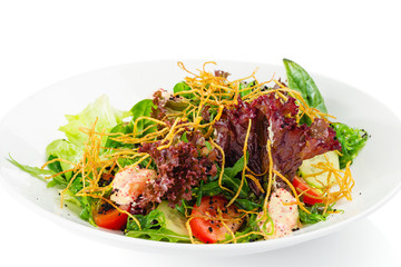 Fresh green salad mix with tomatoes, cucumber, spinach and fried potatoes chips