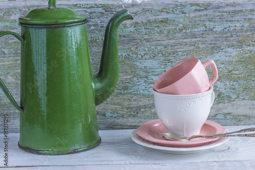 Vintage Green Coffee Pot And White Pink Cups On Rustic Background Vintage Green Coffee Pot And White Pink Cups On Rustic Background