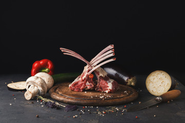 Raw cut rack of lamb on wooden board © Prostock-studio