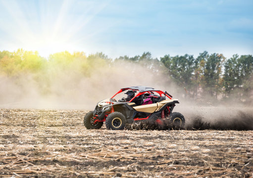 Quad bike on plowed field in the bright sun