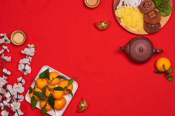 Vietnamese food for Vietnam Tet holiday, also lunar new year of Asia, colorful preserved fruit as kiwi, damson jam, or coconut jam set up on white plate with green wood background make art