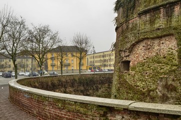 Fototapeta na wymiar Casale Monferrato, Piedmont, Italy 6 January 2018. Paleologi Castle, external walls in red brick and defensive moat.