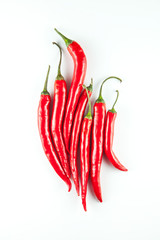 group of red, spicy peppers decorated on white background