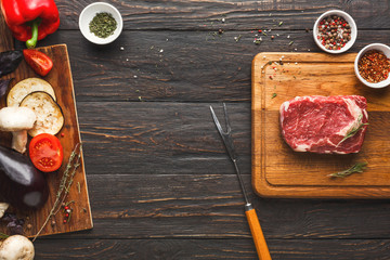 Raw beef filet mignon steaks on wooden board
