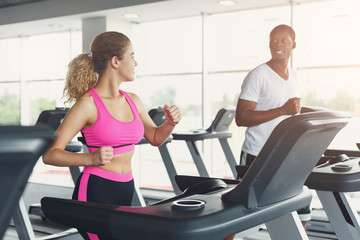 Fototapeta premium Man and woman, couple in gym on treadmills