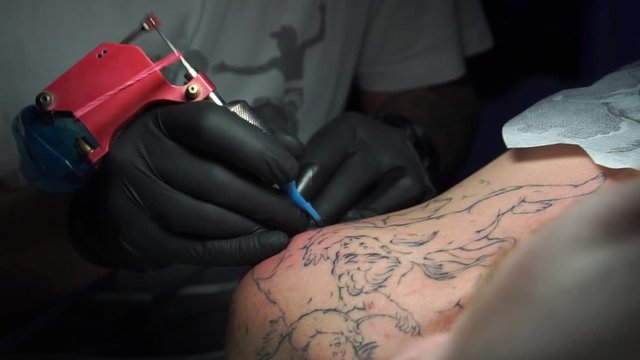 Tattoo artist make tattoo at the studio