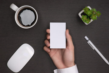 Obraz premium Mockup of white business cards in man's hand