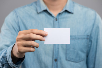 Cropped image of a man holding white business card