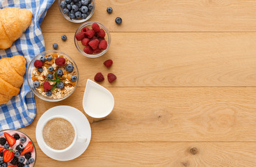 Continental breakfast with croissants and berries on natural wood