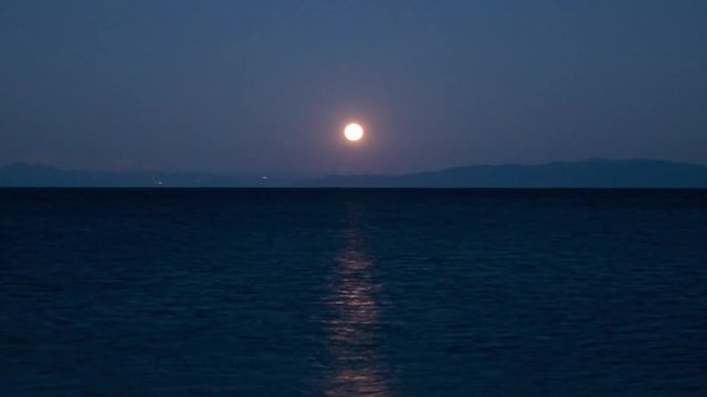 The Full Moon Rising over the Ocean