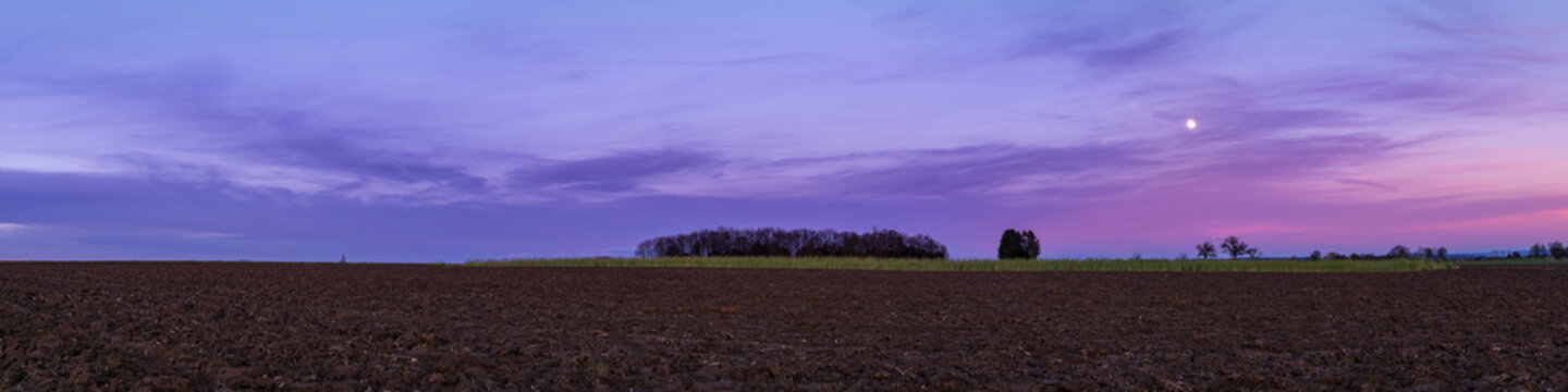 Germany, Baden-Wuerttemberg, Beautiful colourful afterglow sky over a field, extra large panorama