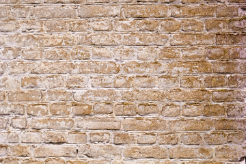 Wall of an old yellow brick. Textured surface for background.