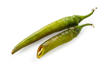 Green chili peppers closeup isolated on white background