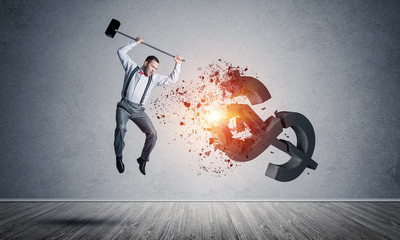 Determined banker man in empty concrete room breaking dollar fig