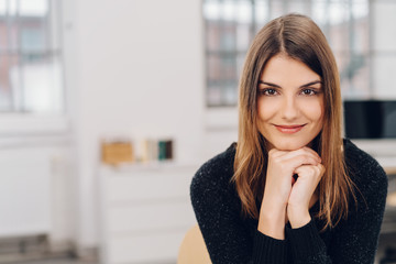 Smiling young woman leaning on her hands