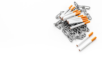 Quit smoking. Cigarettes in chains on white background copyspace