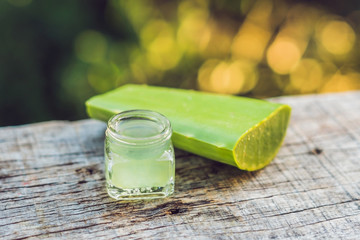 Slices of a aloe vera leaf and a bottle with transparent gel for medicinal purposes, skin treatment...