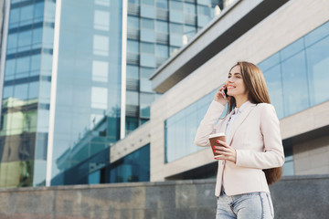 Fototapeta premium Portrait of a confident young businesswoman talking on cell