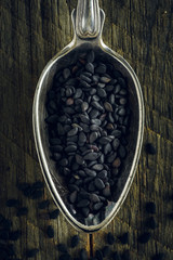 Black sesame seeds in a spoon