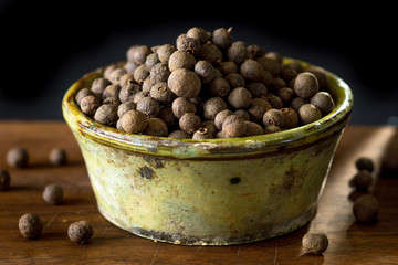 Allspice on rustic background