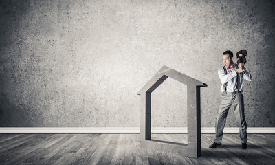 Stone home silhouette in empty room as symbol for real estate in