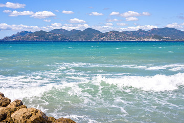 Daylight sunny view from rocks to blue sea and mountains