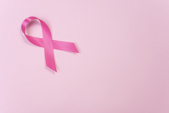 pink ribbon breast cancer on pink background. with copy space