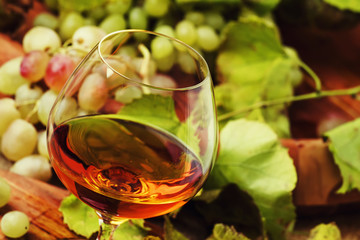 Cognac In Glass, Grapes And Vine, Vintage Wood Background, Selective Focus