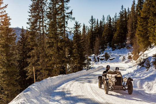 Vintage Racing Car Driving Classic Rally On Snow Covert Road