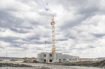 Fototapeta na wymiar Lift crane building a new residential building