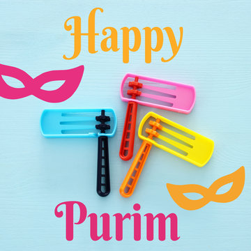 Purim celebration concept (jewish carnival holiday). Top view of noise maker traditional toy.