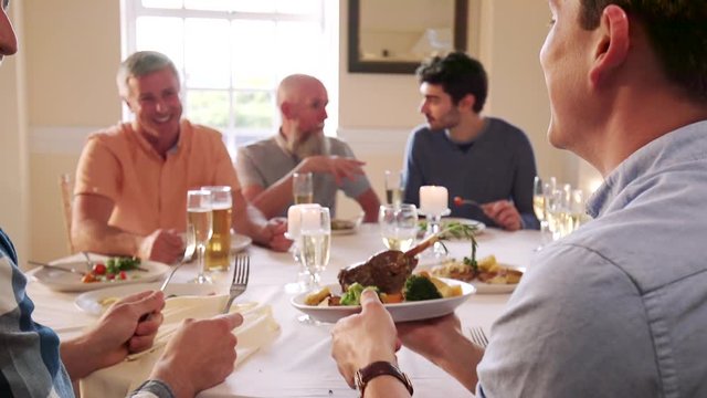 Men Eating At A Dinner Party