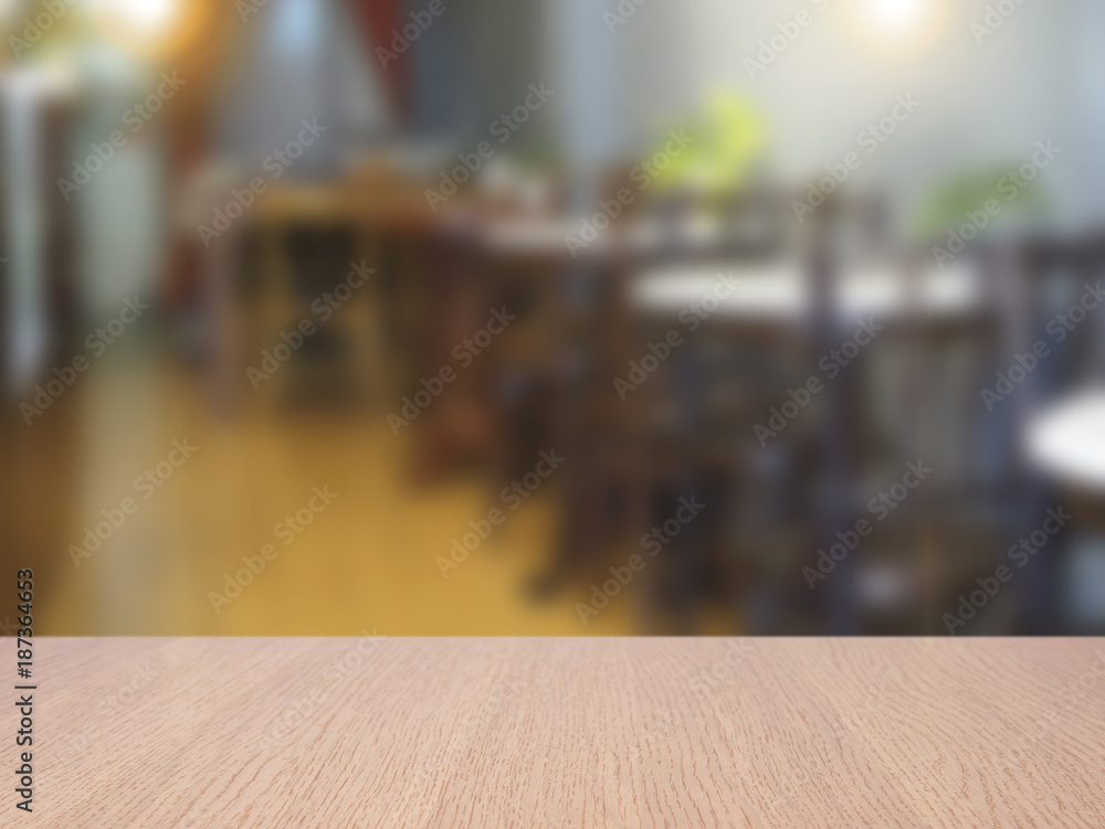 Wall mural top empty wood table on blurred abstract cafe background. can be used for display or montage your pr