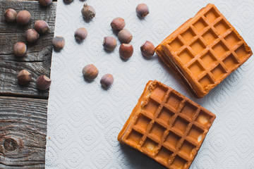 Waffle on a wooden background on a white napkin