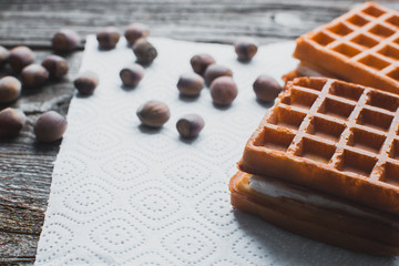 Waffle on a wooden background on a white napkin