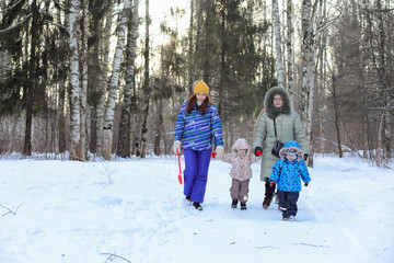 Family with kids in winter park on weekend