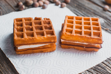 Waffle on a wooden background on a white napkin