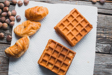 Waffle on a wooden background on a white napkin