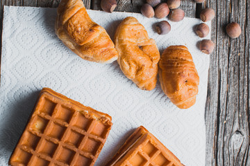 Waffle on a wooden background on a white napkin