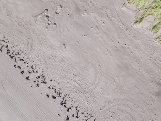 Aerial View looking down on a Welsh Beach in the UK. Looking straight down at the great expanse of a textured sandy beach, Taken 400 feet in the air by a drone.