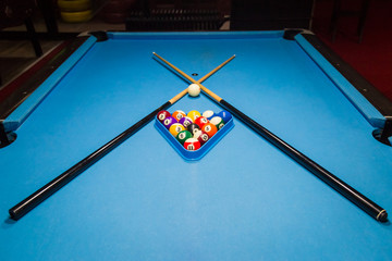 Billiard pool balls in triangle and sticks on table