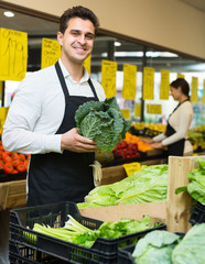 Fototapeta premium Seller with vegetables in market.