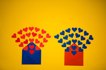 Greeting envelope with paper hearts on yellow background. Hearts pours out of the envelope. Hearts...
