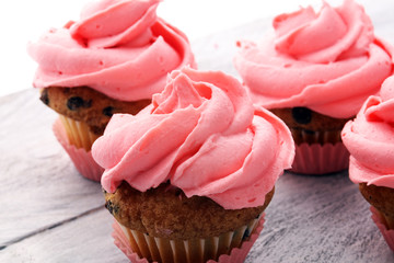 Tasty cupcakes on wooden background. Birthday cupcake in pink color