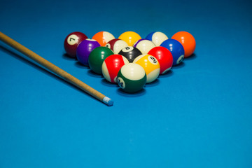 Billiard pool balls in triangle and stick on table