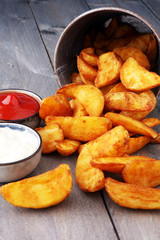 French fries potato with ketchup and mayonnaise on wooden background