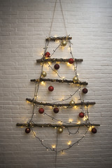 Christmas tree with xmas toys, balls and lights, handmade