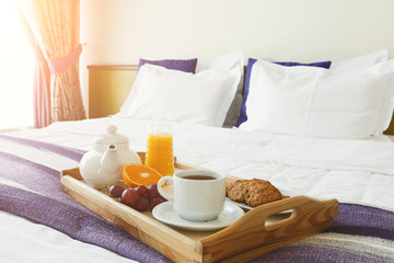 Fototapeta na wymiar Breakfast served in bed on wooden tray