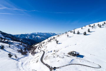 Fototapeta na wymiar Aerial View of skiers at Ski Resort Vasilitsa in the mountain range of Pindos, in Greece.