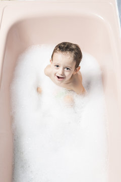 Child playing in a bubble bath